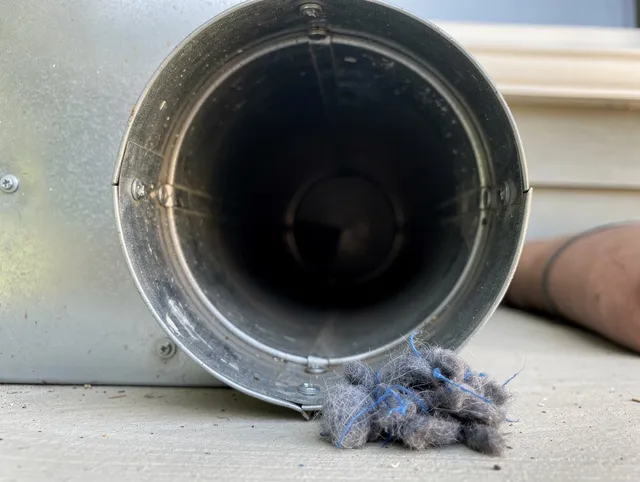 Davidson Dryer Vent Cleaning technician using specialized equipment to clear severe dryer vent blockage in Davidson